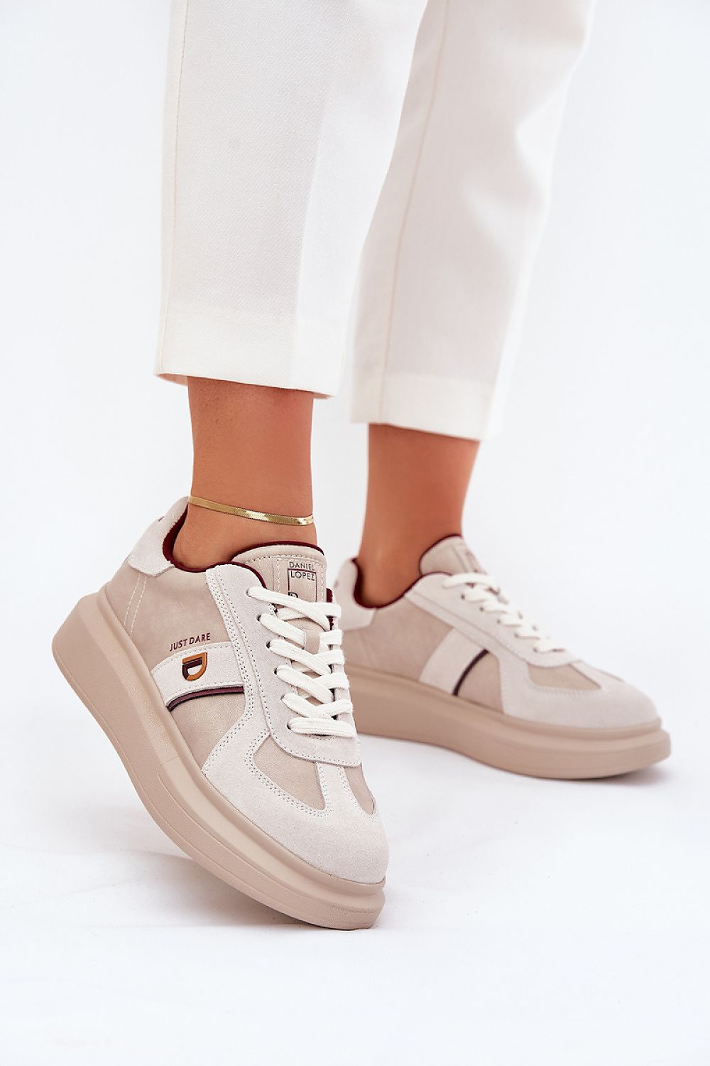 Caravelle mixed-leather platform sneakers with suede accents and elevated sole, worn with white pants for a chic look.