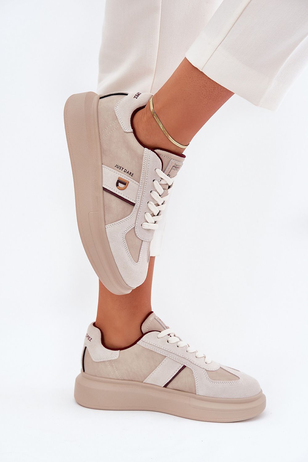 Woman wearing Caravelle Mixed-Leather Sneakers with platform, combining smooth leather and suede for a stylish, comfortable look.
