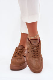 Brown Caravelle Mixed-Leather Sneakers with suede finish and platform sole, worn by a person in white pants. Fashion footwear.