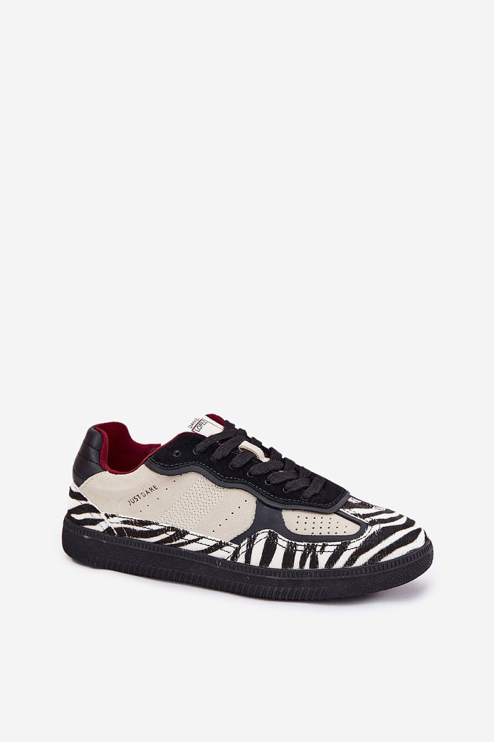 Zebra pattern sneaker with suede details and a black sole, showcasing a unique urban style design for modern wardrobes.