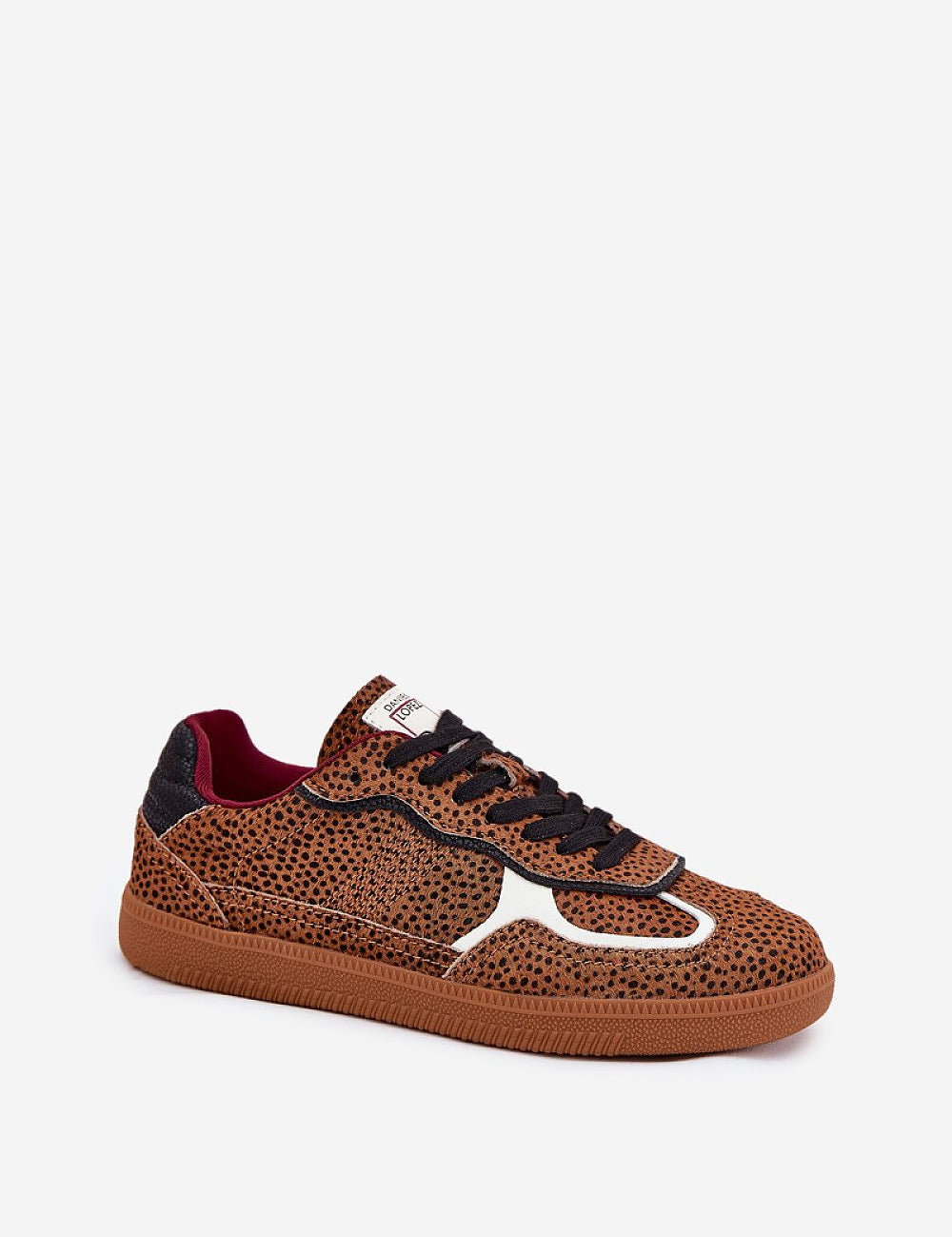 Leopard print low-top sneaker with black laces and a thick brown sole, featuring a modern design suitable for casual wear.
