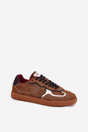 Leopard print low-top sneaker with black laces and a thick brown sole, featuring a modern design suitable for casual wear.