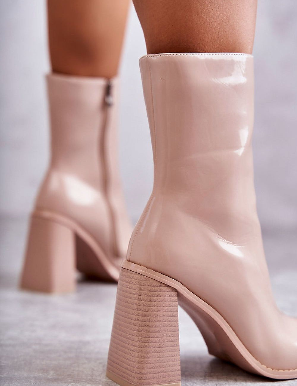 Glossy mid-calf boots with lacquered finish and block heels in nude, featuring side zipper and eco-leather design for style and comfort.