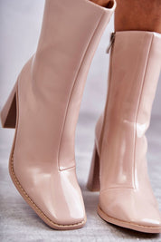 Glossy beige mid-calf boots with a lacquered finish, featuring a pointed toe and slim stiletto heel, crafted from eco leather.