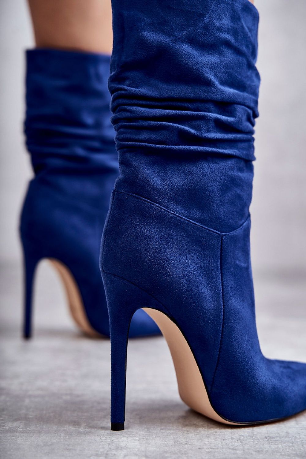 Celvarine Silkwrinkle Tall Poise high-ankle blue eco suede boots with stiletto heel and pointed toe, showcasing graceful creasing.