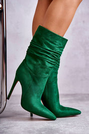 Green high-ankle boots with pointed toe and stiletto heel, featuring graceful creasing and eco suede material for a stylish silhouette.