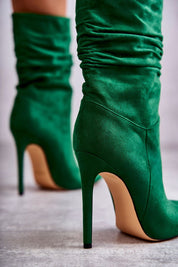 Green high-ankle eco suede boots with stiletto heels and stylish creases, designed for elegance and silhouette elongation.
