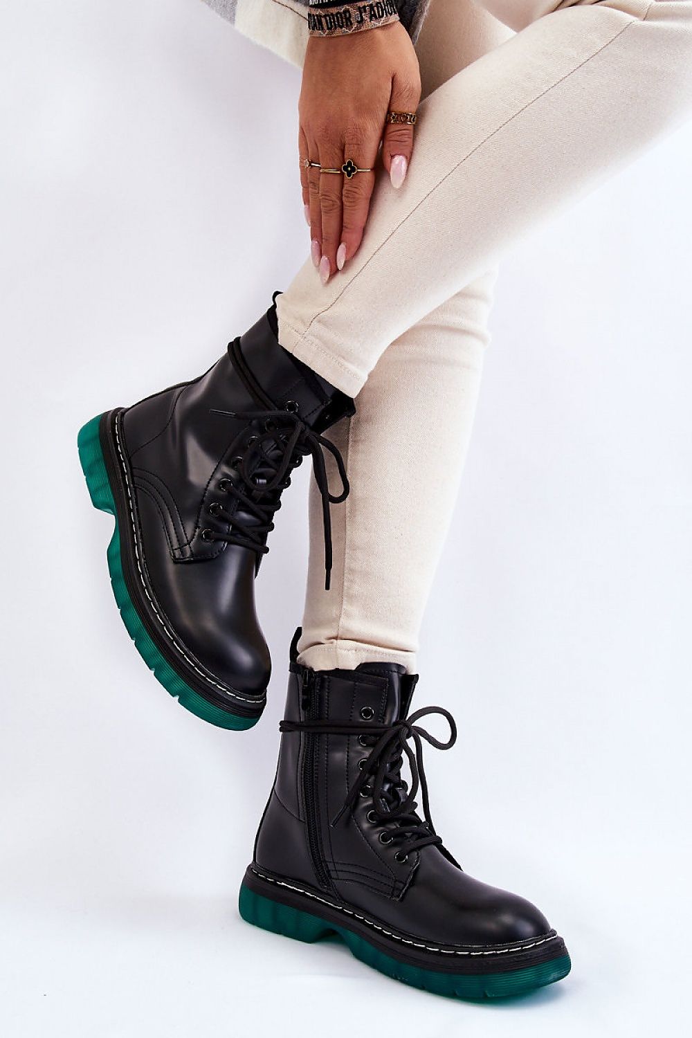 Varnisse Hollowtread platform boots with lace-up design and green treaded sole, showcasing style and functionality.