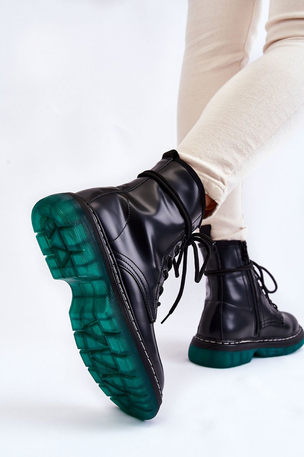 Varnisse Hollowtread Warm Structure boots with green treaded sole and black eco leather, showing side view and lace-up design.