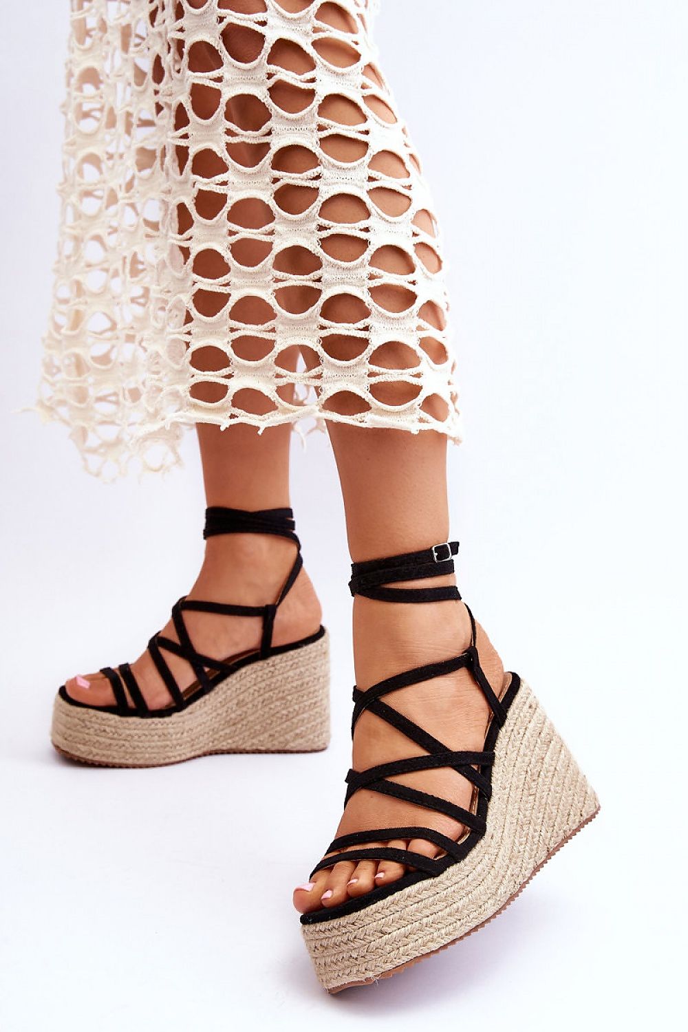 Woman wearing Ardavia Jute Platform Sandals with faux suede straps and jute base, styled with a crochet skirt.
