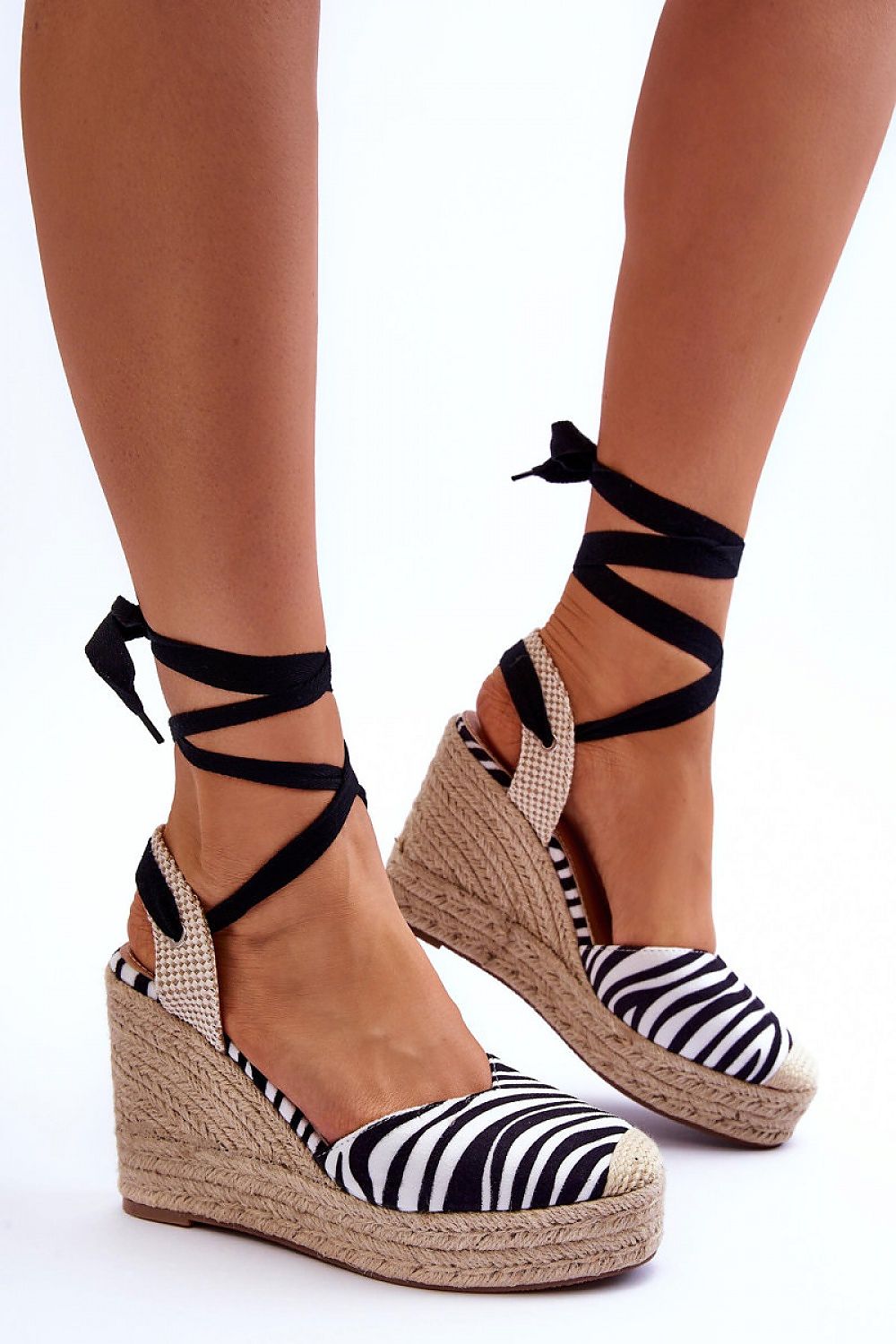 Zebra print lace-up platform sandals with jute-wrapped wedges and black calf ties, perfect for boho style and comfort.