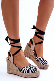 Zebra print lace-up platform sandals with jute-wrapped wedges and black calf ties, perfect for boho style and comfort.