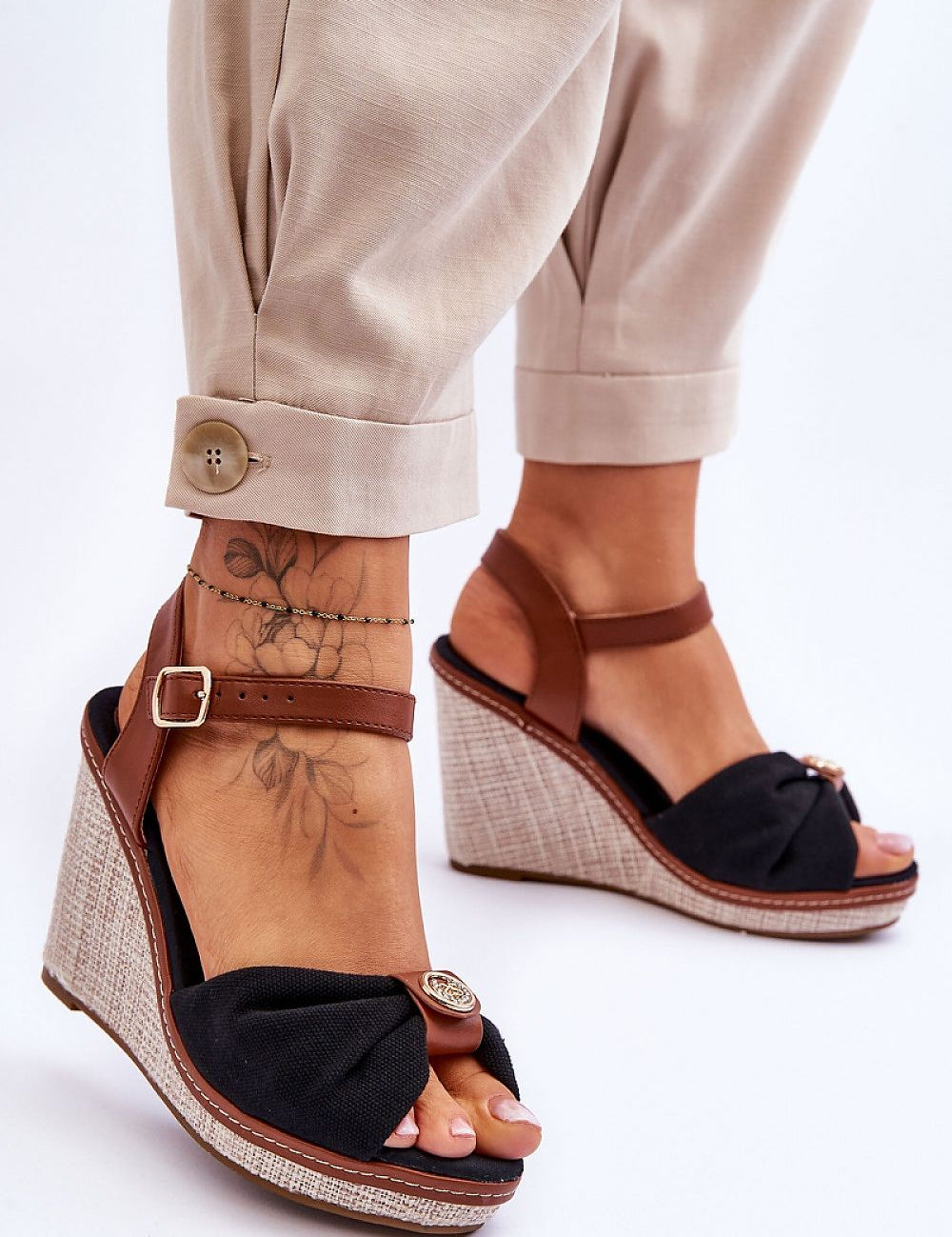 Woman wearing Arvola Rhinestone Platform Buskins with ankle strap, high heel and platform, featuring black textile and rhinestone detail.