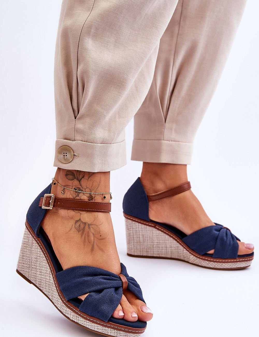 Woman wearing Larvella Woven Fabric Buskins, showcasing stylish blue woven sandals with a sculpted heel and buckle-fastened ankle strap.