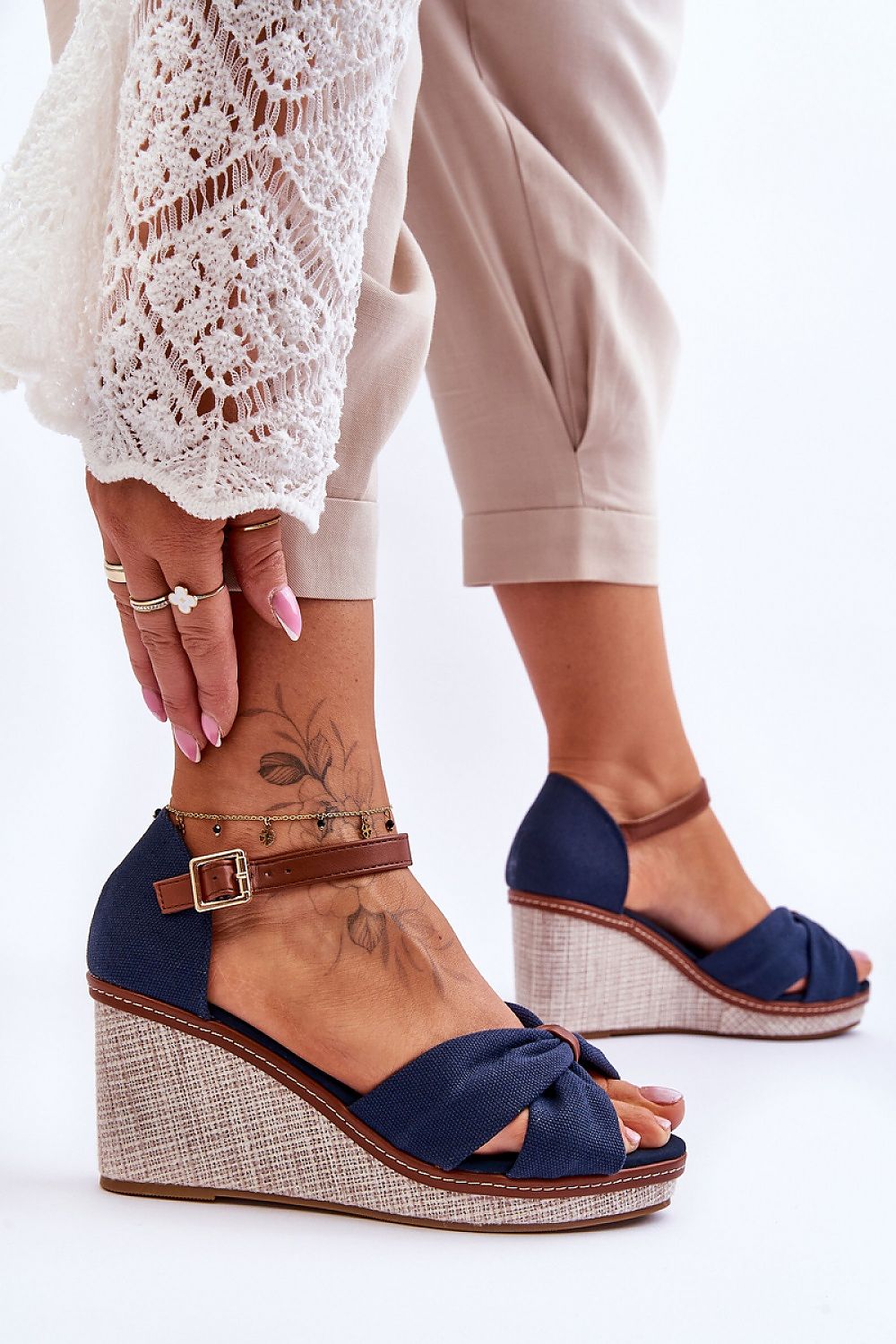 Woman wearing Larvella Woven Fabric Buskins, blue fabric sandals with a wedge heel, ankle strap, and non-slip sole.