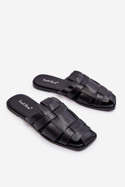 Black woven slip-on flat flip-flops with cushioned insole on a white background.