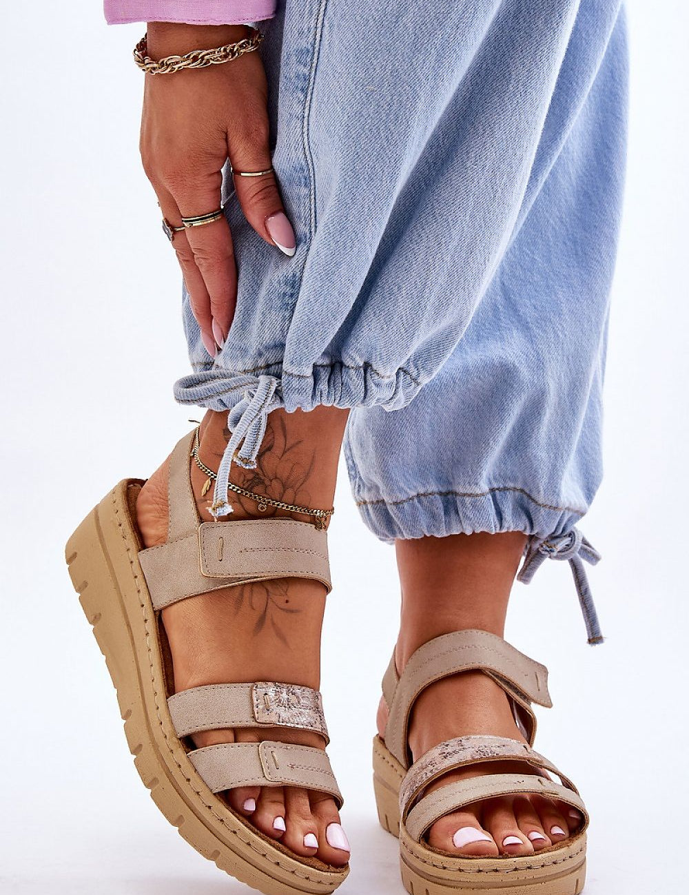 Woman wearing Sivetta Cushioned Platform Sandals in beige eco leather with Velcro fastening, styled with casual blue jeans.