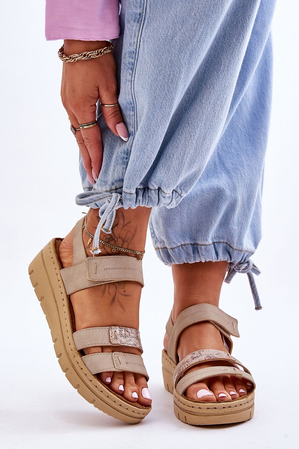 Woman wearing Sivetta Cushioned Platform Sandals in beige eco leather with Velcro fastening, styled with casual blue jeans.