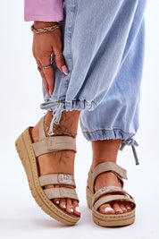 Woman wearing Sivetta Cushioned Platform Sandals in beige eco leather with Velcro fastening, styled with casual blue jeans.