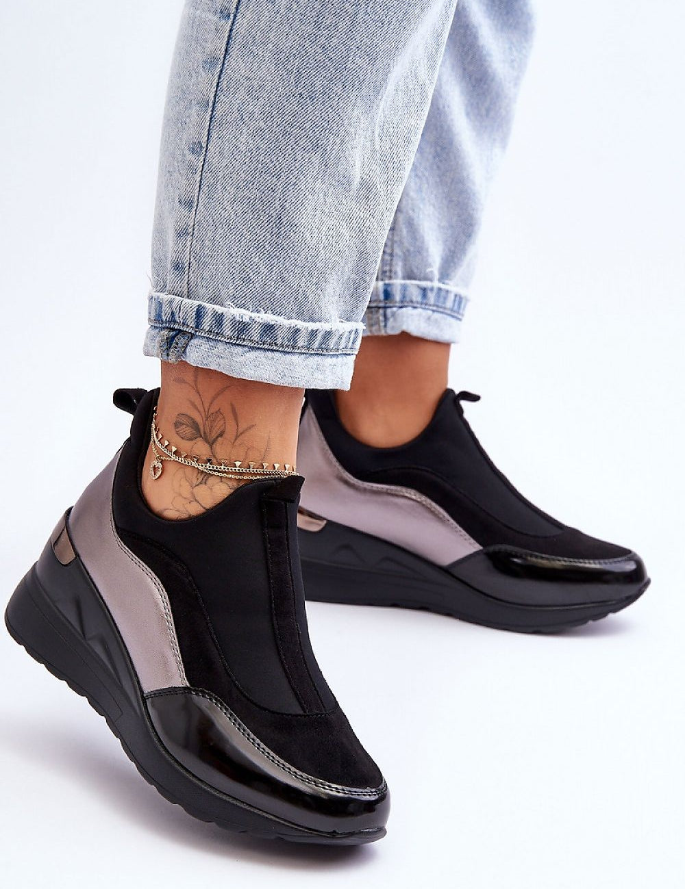 Lestora Dual-Layer Slip-On Sneakers with soft-touch fabric and eco-leather, offering elegance and comfort paired with denim jeans.