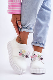 Woman wearing Verelune Crystal Platform Slip-Ons with eco-suede texture and crystal accents, showcasing style and comfort.