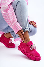 Woman wearing Verelune Crystal Platform Slip-Ons with pink eco-suede texture, crystal accents, and thick platform sole for style.