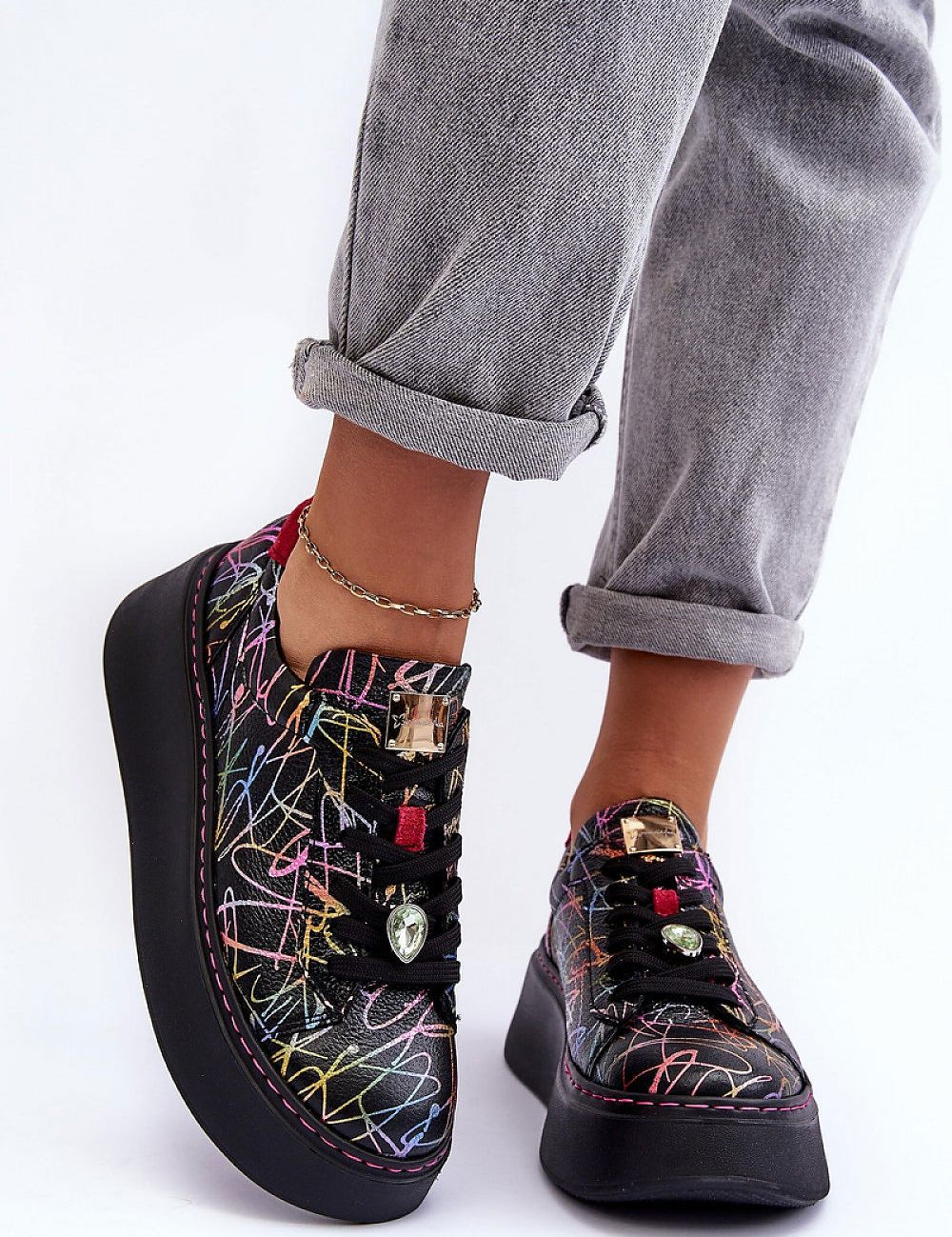 Person wearing Rinalve Leather Platform Sneakers with colorful pattern, showcasing comfort and style on a sculpted platform sole.