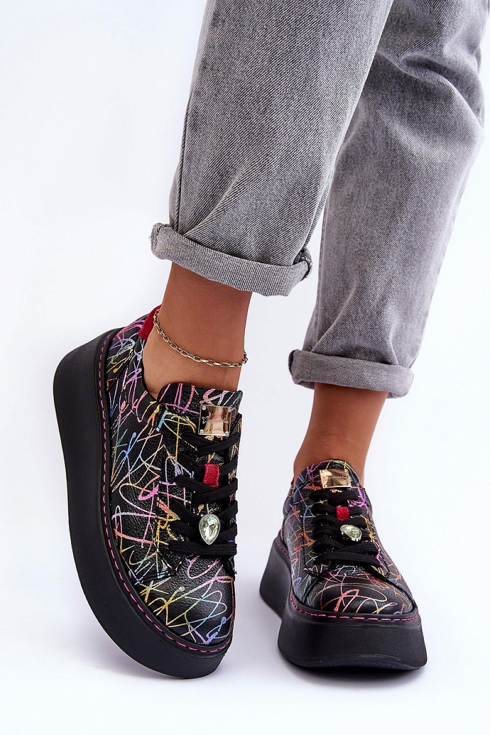 Person wearing Rinalve Leather Platform Sneakers with colorful pattern, showcasing comfort and style on a sculpted platform sole.