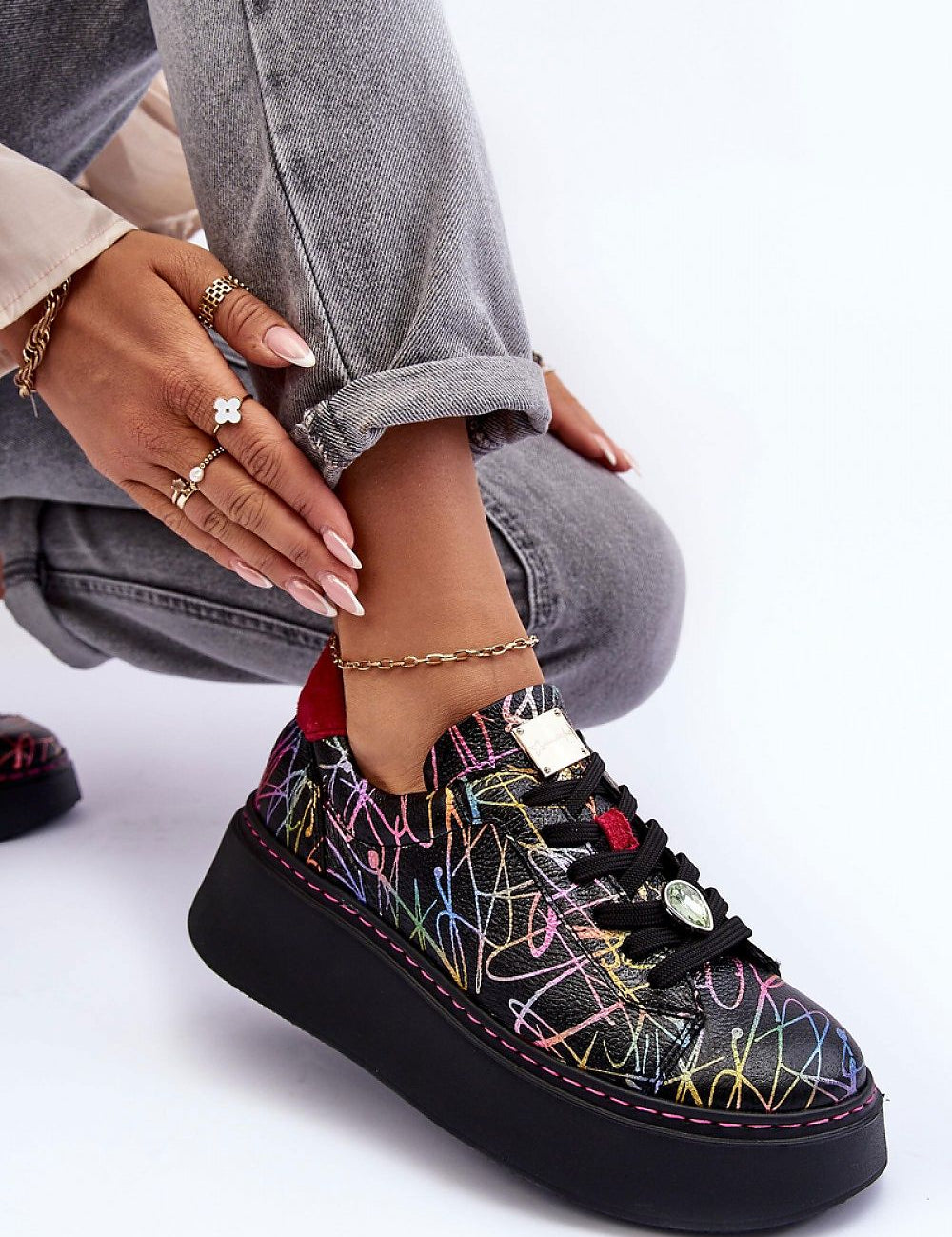 Rinalve Leather Platform Sneakers with colorful design, showcasing comfort and style with a sculpted platform and jewelry charm, worn with light jeans.