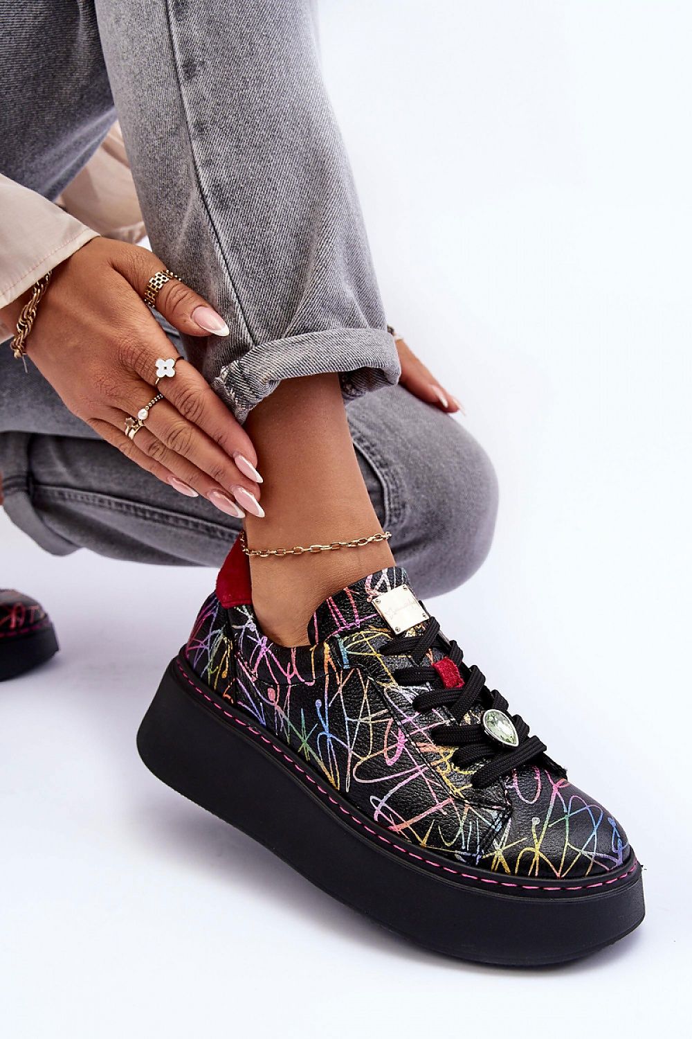 Rinalve Leather Platform Sneakers with colorful design, showcasing comfort and style with a sculpted platform and jewelry charm, worn with light jeans.