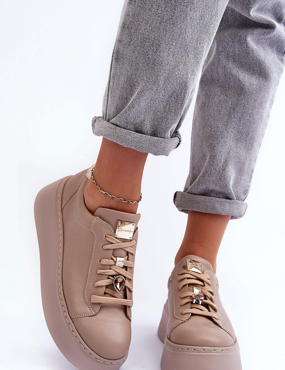Beige Rinalve Leather Platform Sneakers with jewelry charm, worn with rolled-up jeans for stylish comfort.