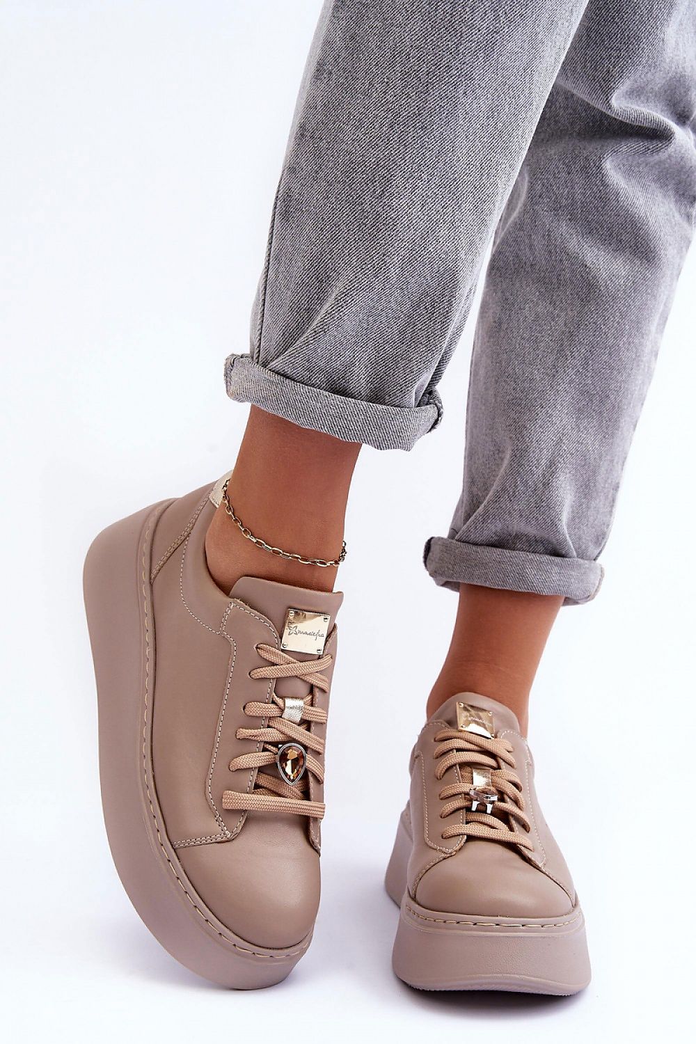 Beige Rinalve Leather Platform Sneakers with jewelry charm, worn with rolled-up jeans for stylish comfort.