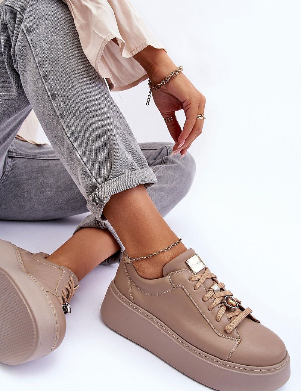 Rinalve Leather Platform Sneakers with jewelry charm, showcasing comfort and style, worn with jeans for a chic look.