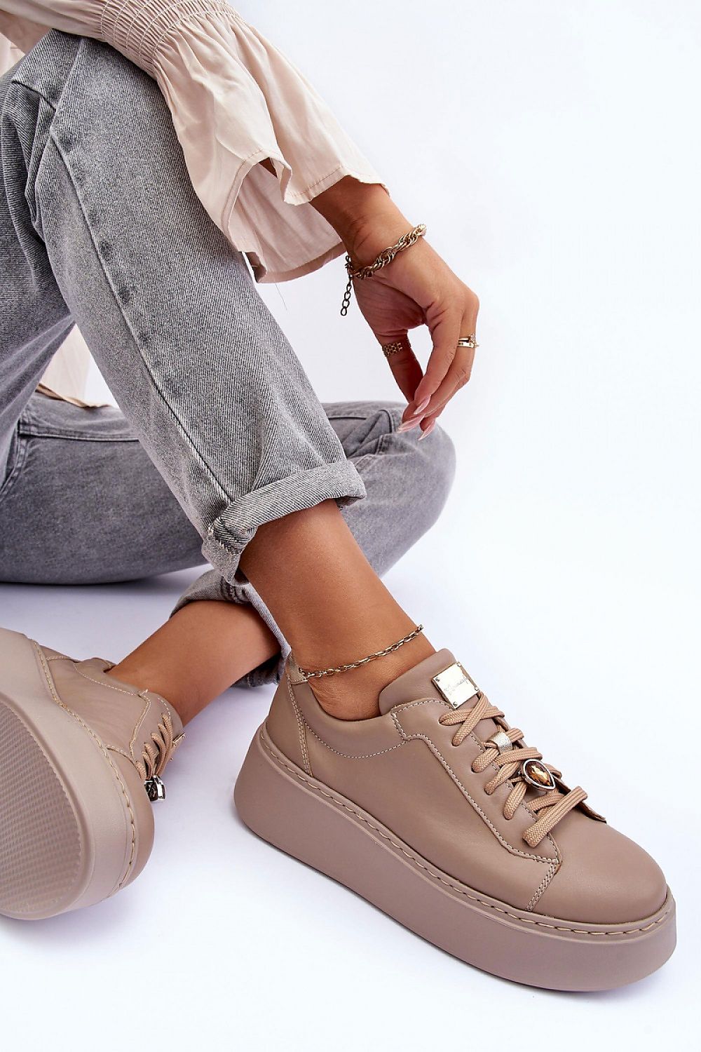 Rinalve Leather Platform Sneakers with jewelry charm, showcasing comfort and style, worn with jeans for a chic look.