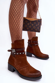 Woman wearing Morena Matte Vegan Leather Boots paired with patterned tights and holding a designer clutch.