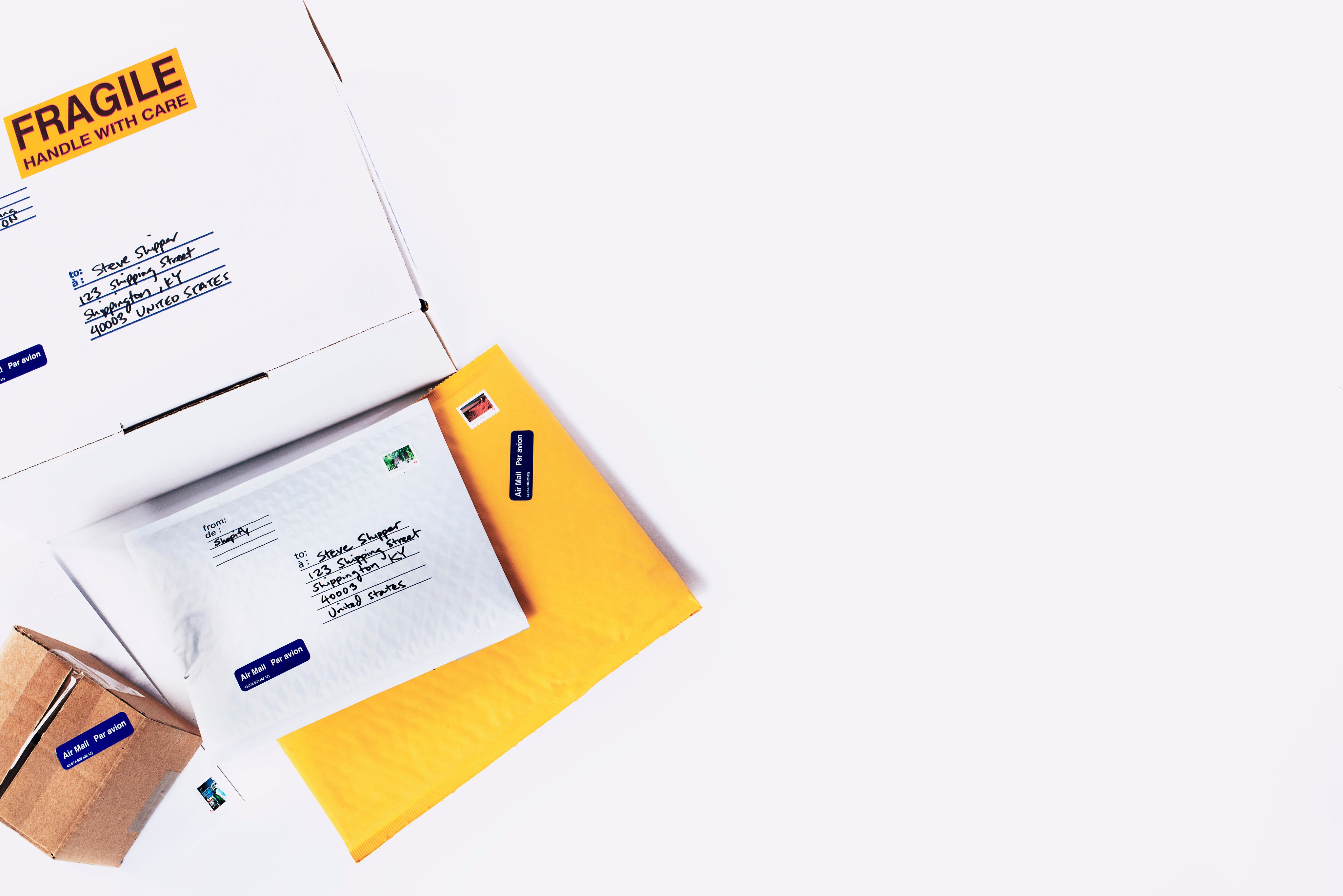 Assorted envelopes and packages with labels on a white background.